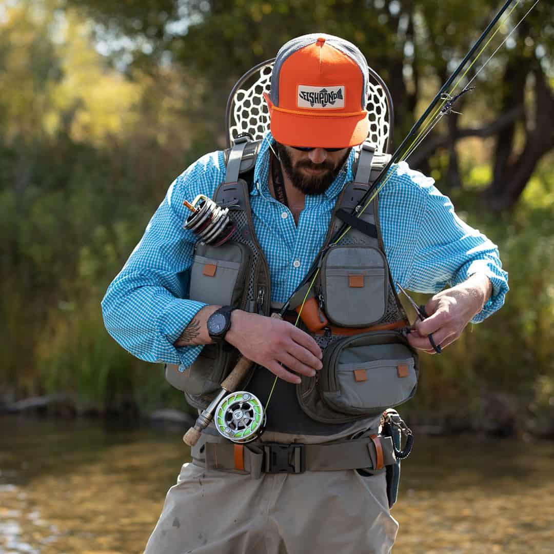 Angler wearing Fishpond Sagebrush Pro Mesh Vest while fly fishing